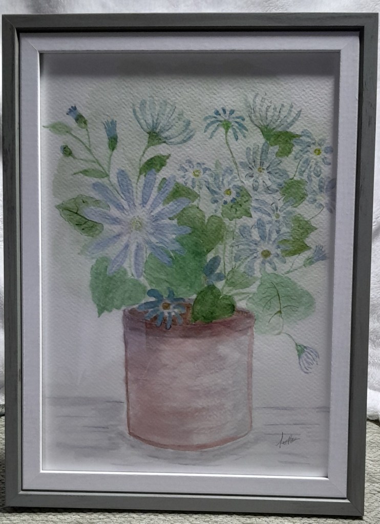 Framed watercolour painting of blue daisy-like flowers in a terracotta pot