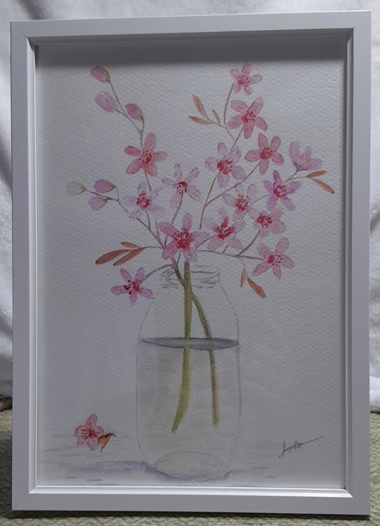 Framed watercolour painting of pink blossom in a glass vase
