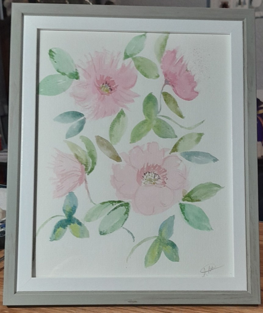 Framed watercolour painting of pink flowers with green leaves